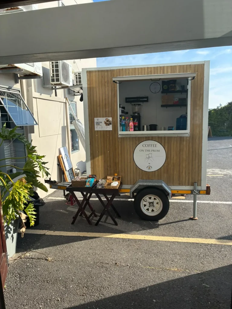 The Apothecary coffee trailer set up with its hatch open at a private event