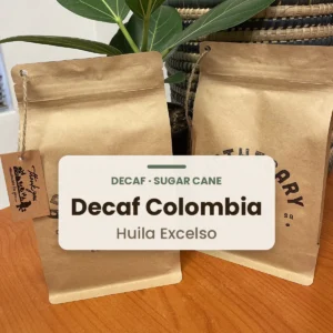 Bag of Apothecary Decaf Colombia Huila Excelso (sugar cane process) coffee beans, labelled